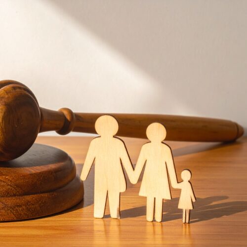 Wooden Judge Gavel and Sound Block Next to a Wooden Family Cutout