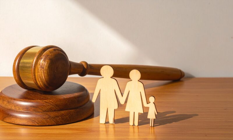 Wooden Judge Gavel and Sound Block Next to a Wooden Family Cutout