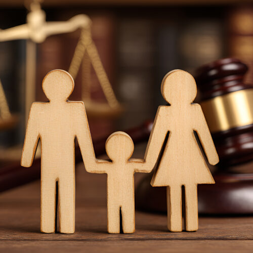 Wooden family figures are holding hands